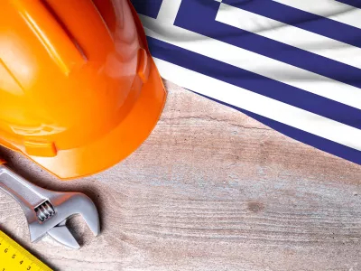 Greece flag and some construction tools on wooden background